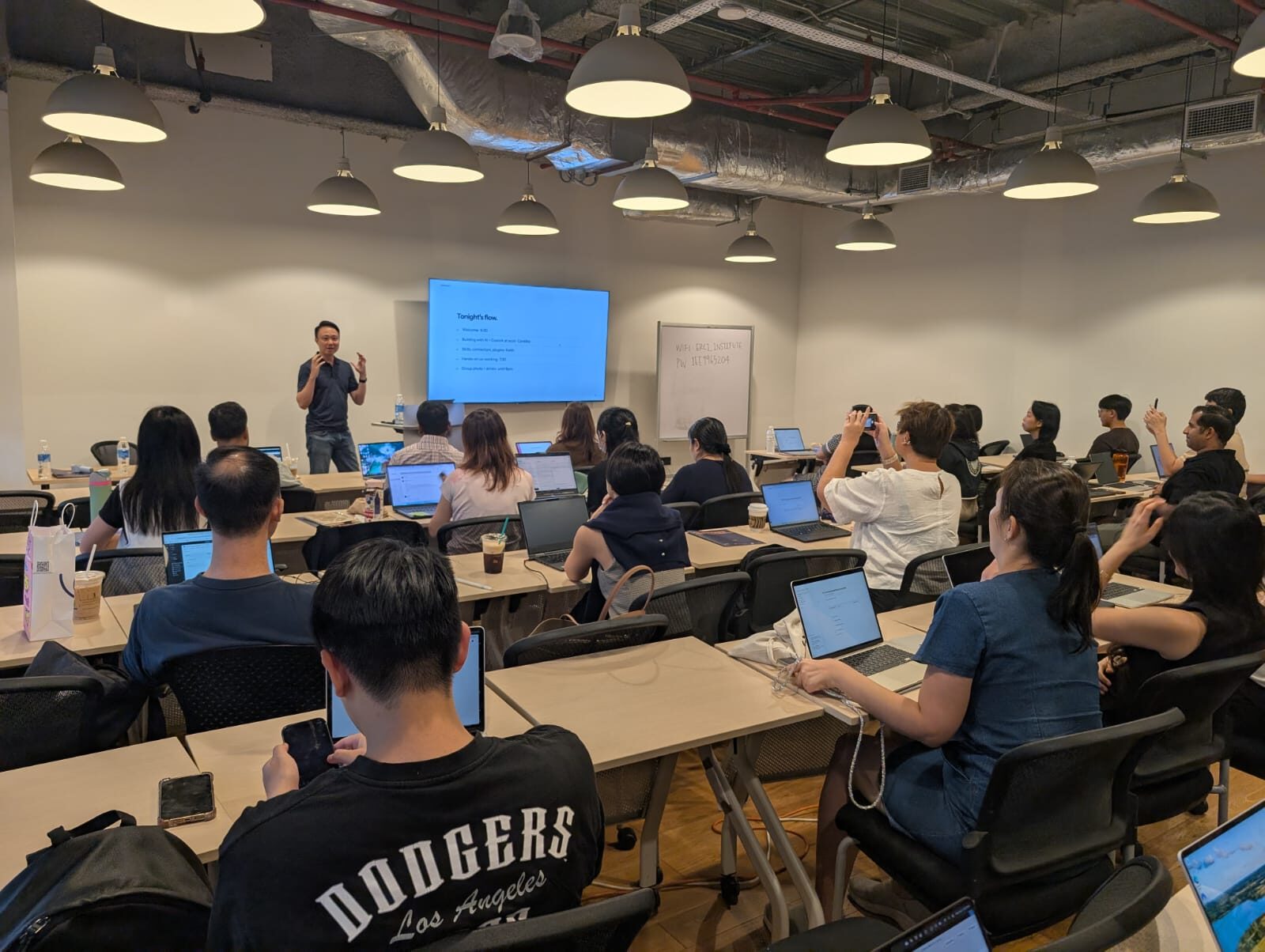 Keith Teo presenting to a full room at AI Power Users Meetup 02