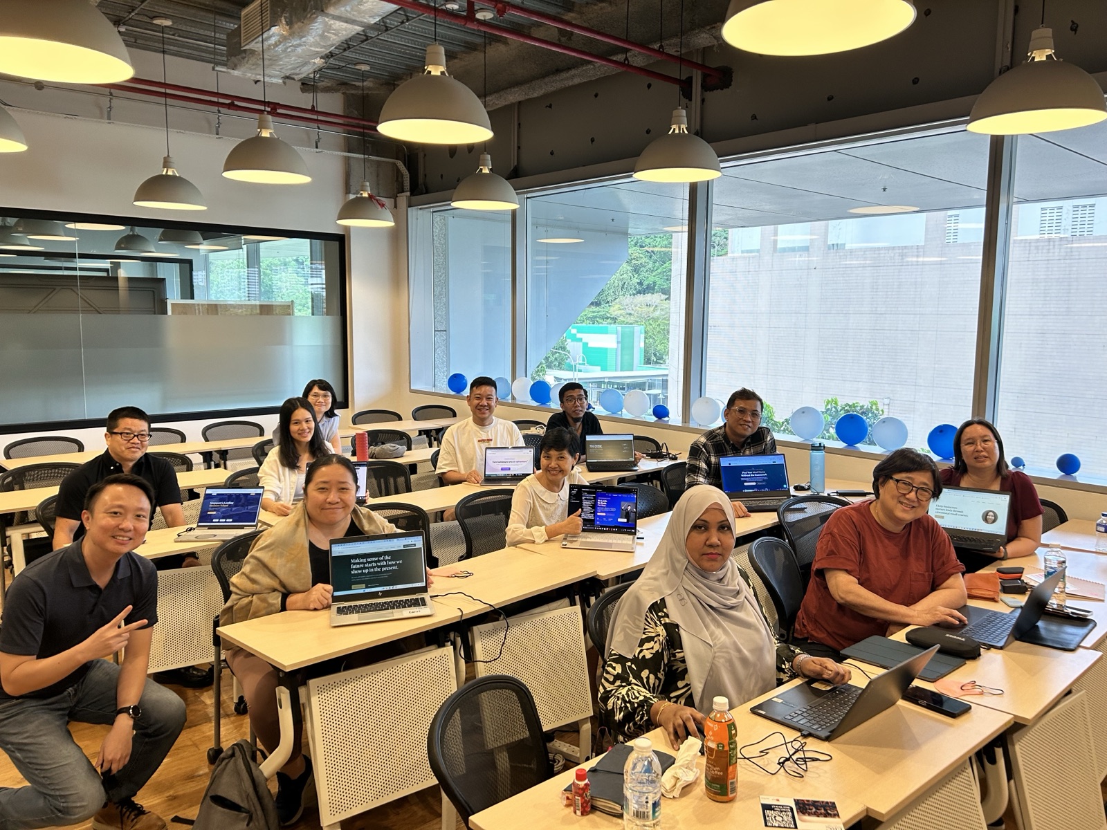 The 27 April 2026 cohort with Keith at ERC Institute, laptops open, websites live